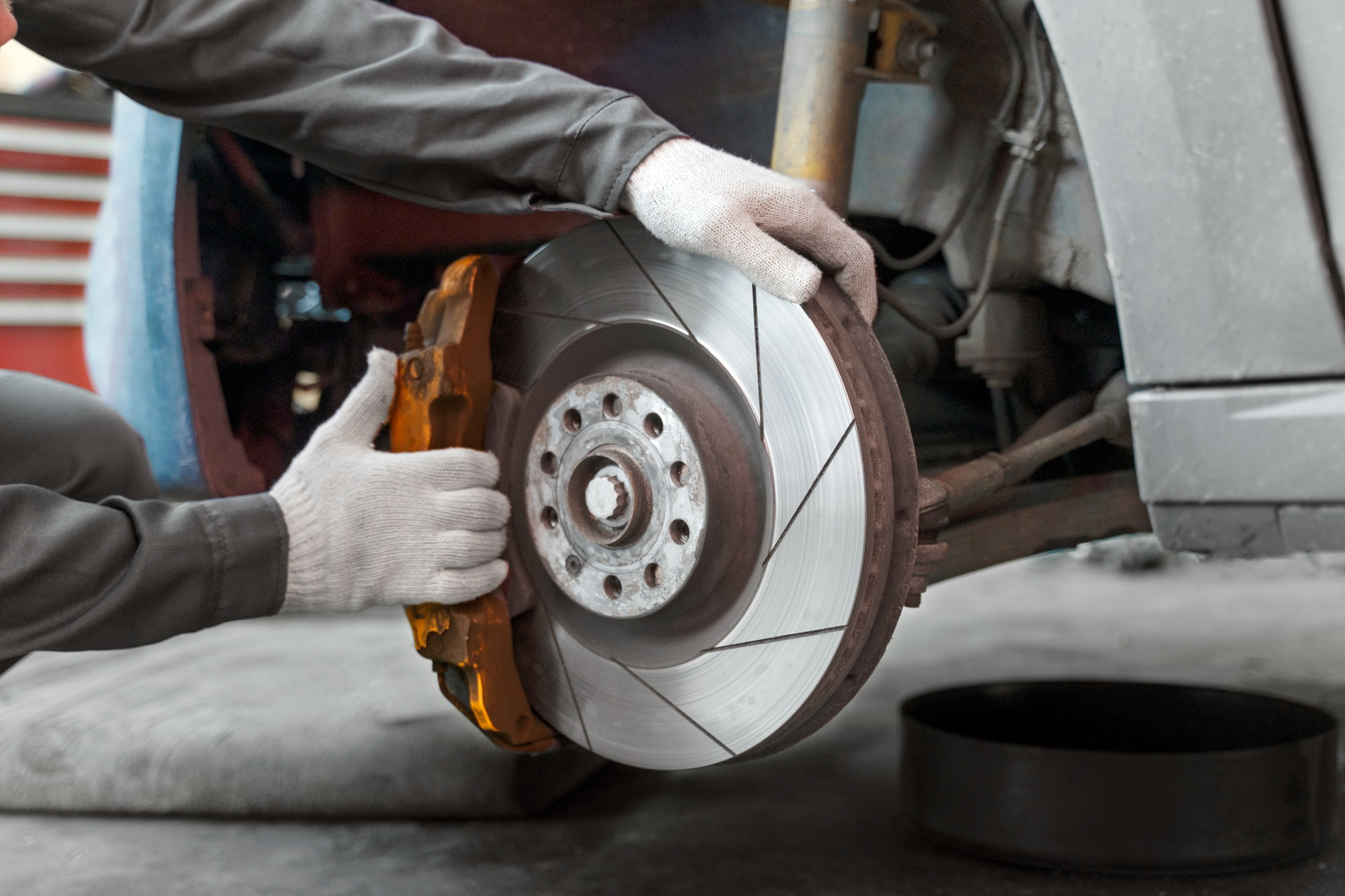 Mechanic repairing worn out brake plate